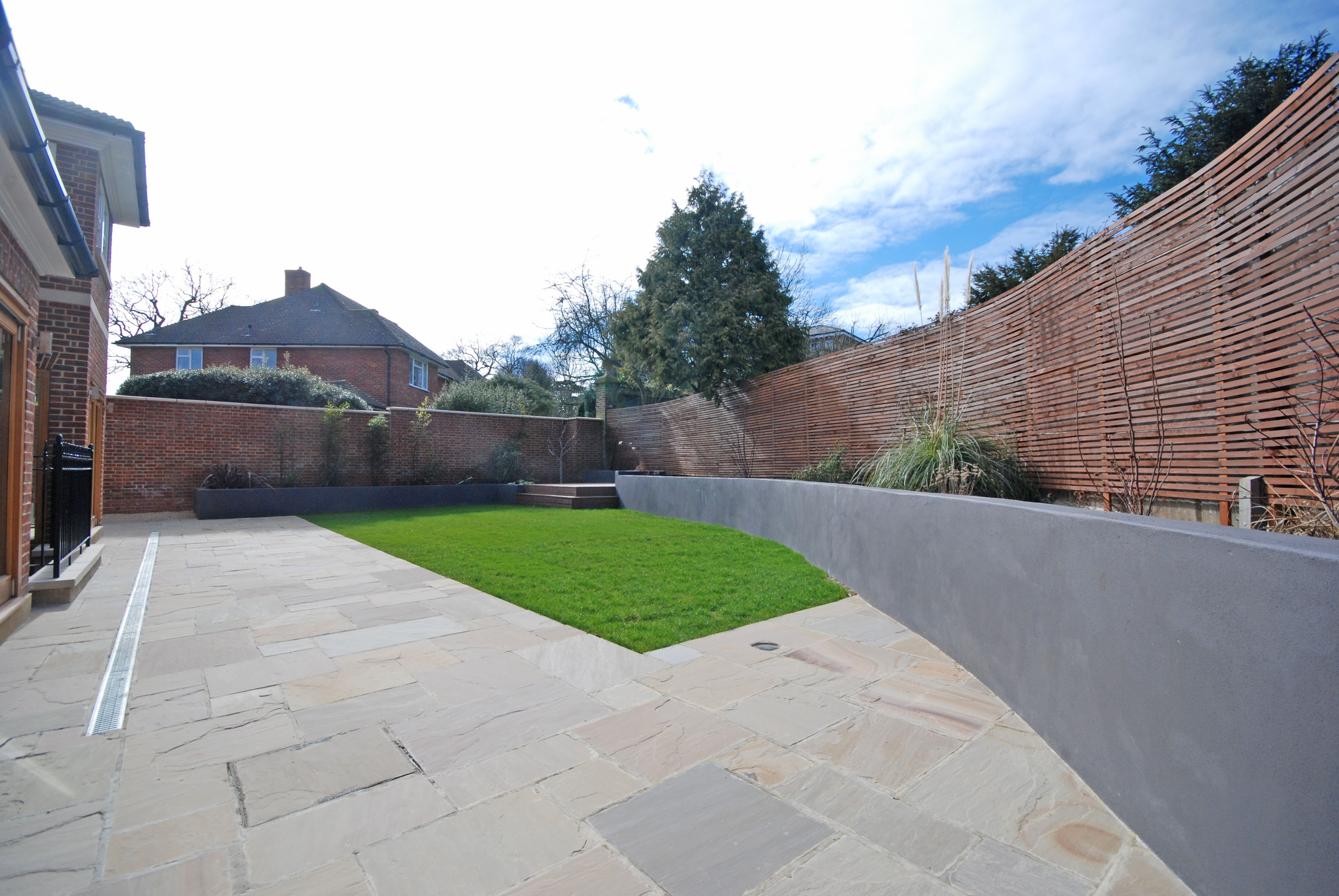 Garden patio with stone paving and raised planters